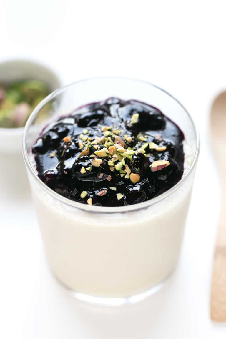 Panna Cotta Vegana - Esta panna cotta vegana es una versión vegetal y más sana de este tradicional postre italiano. Servida con una compota casera de arándanos, es un postre delicioso. #vegano #singluten #danzadefogones