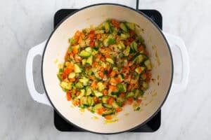 Verduras salteadas en la olla después de echar vino blanco y reducirse.