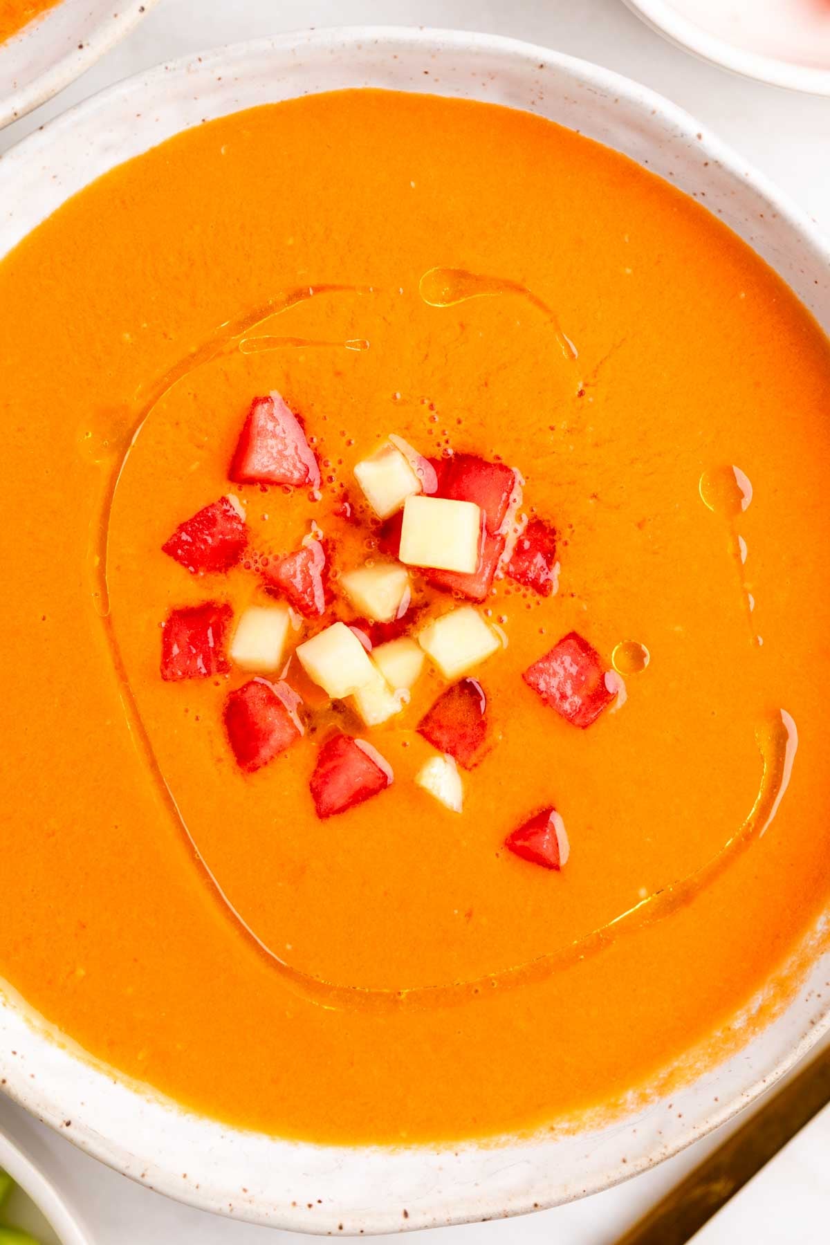 Gazpacho de sandía servido en boles con pepino, sandía y un chorrito de AOVE